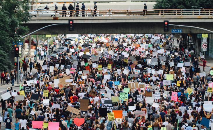 Large crowd gathered with placards in protest